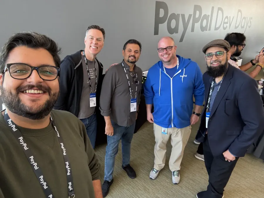Abdul Hannan Shaikh with members of the PayPal developer team under a PayPal Dev Days sign